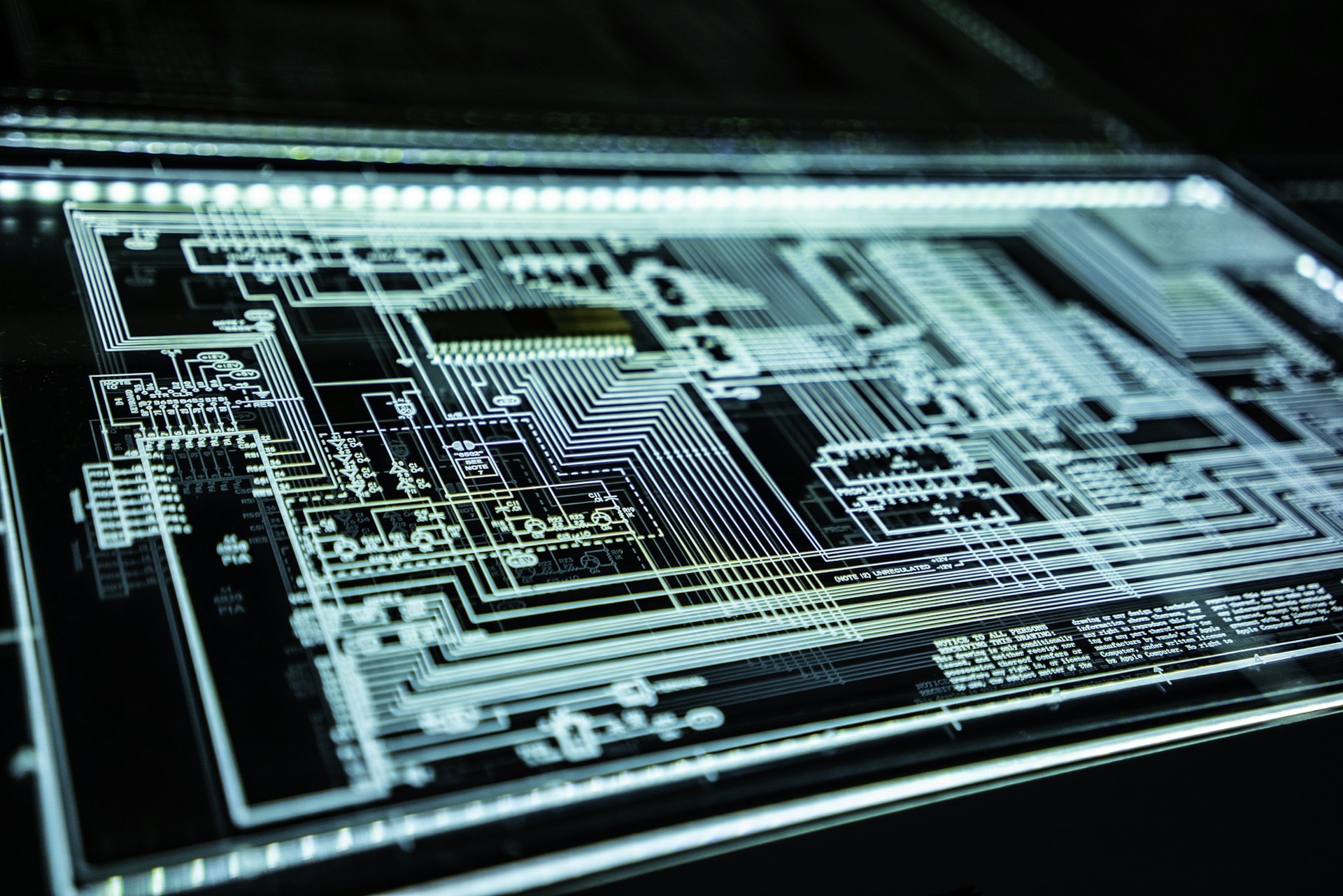 A backlit circuit schematic, traces picked out in white against black.